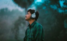 person with headphones on; top podcasts