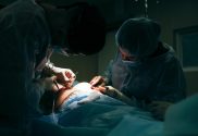 Surgeons at work at an operating table / A University of Pennsylvania study has used a brain dead body to connect to a pig liver