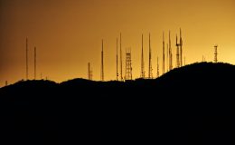 A silhouette image of telecommunications towers